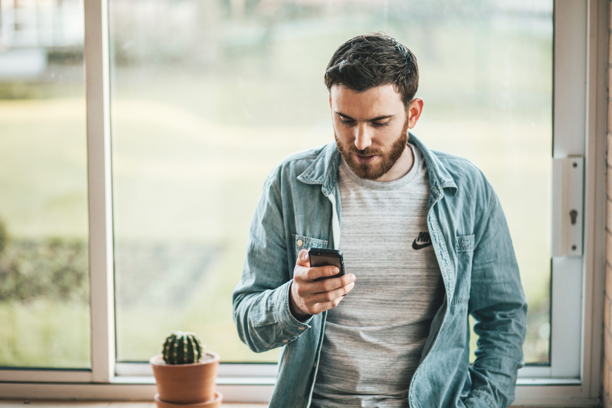 Man staring at his smartphone dealing with digital addiction