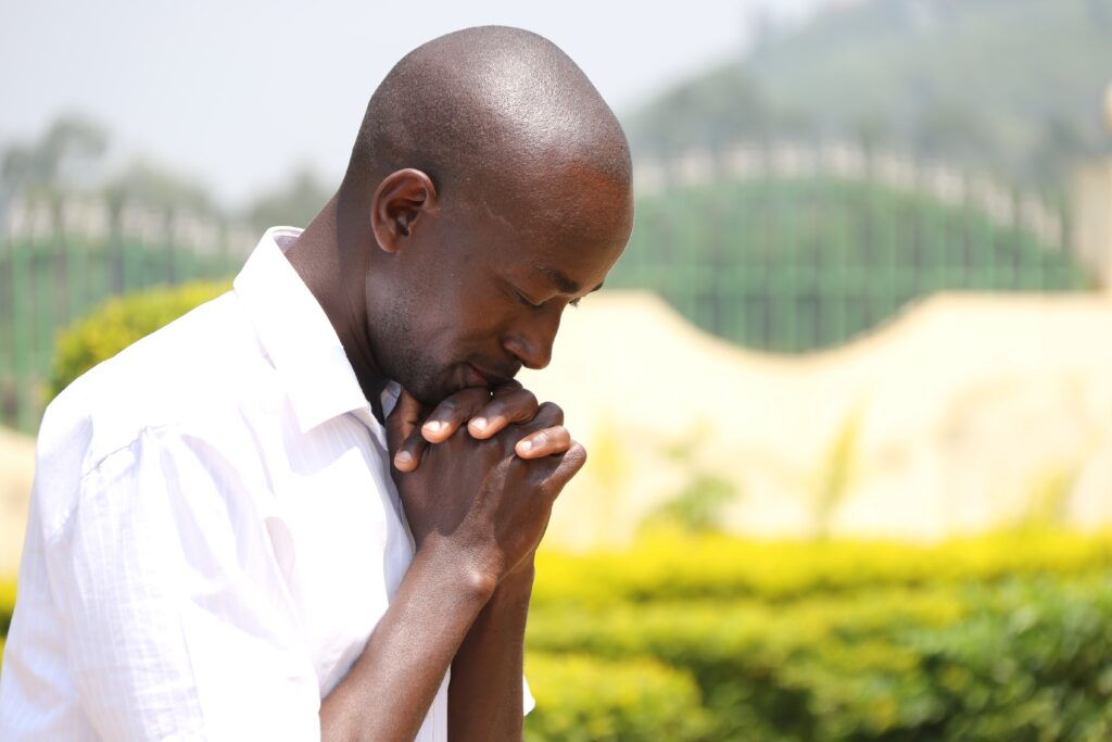black man praying for why the world needs hope