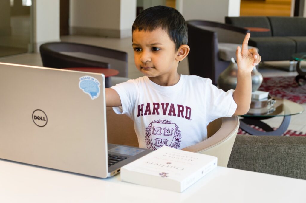 Young boy in front of a computer mastering the power of asking questions