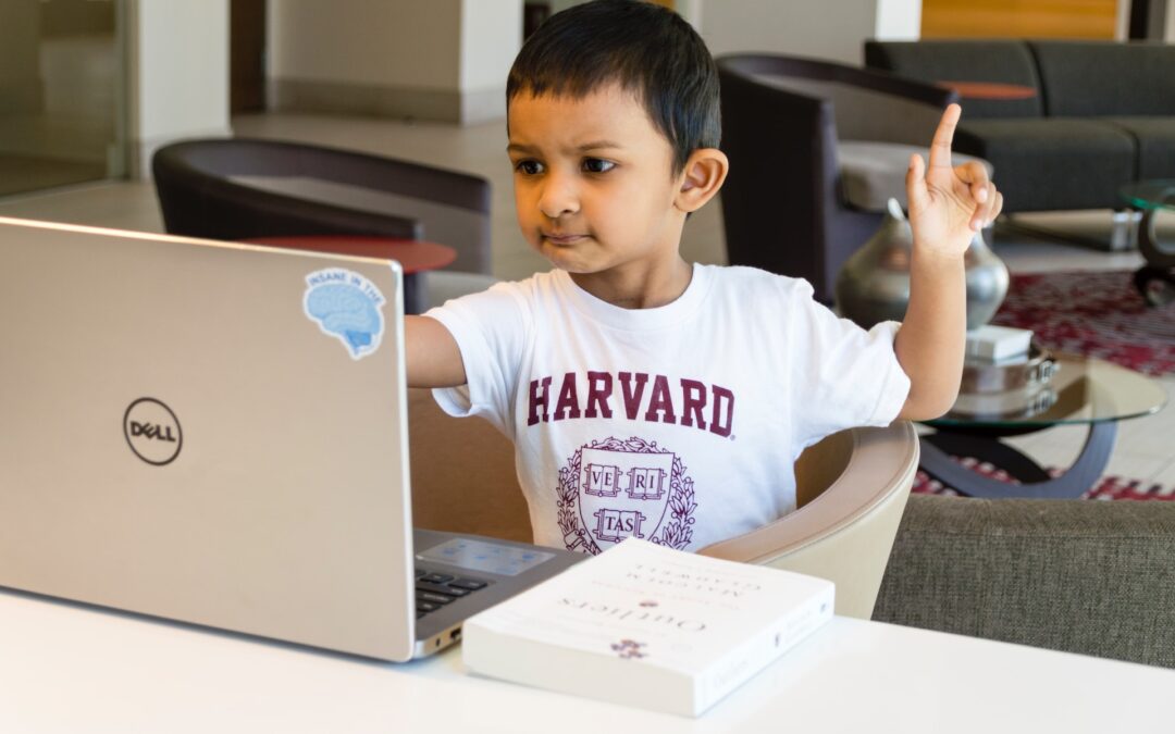Young boy in front of a computer mastering the power of asking questions
