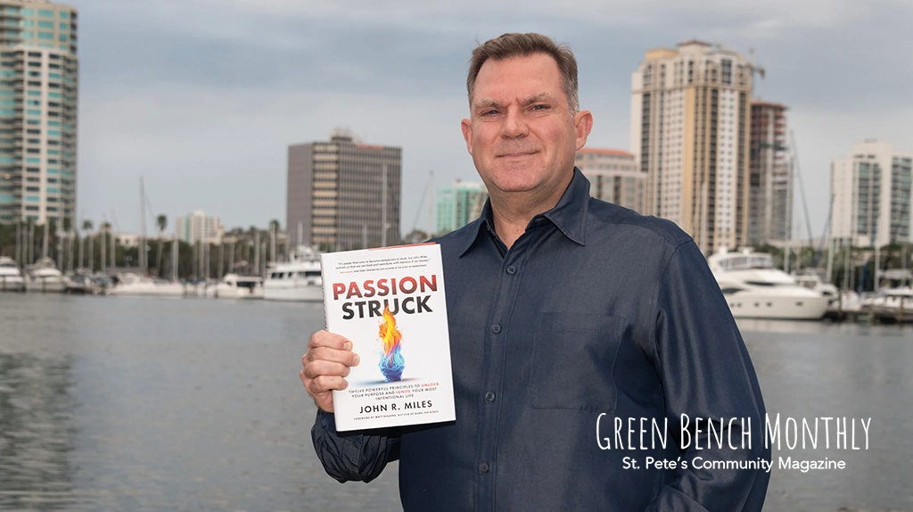 John R. Miles holding his book Passion Struck