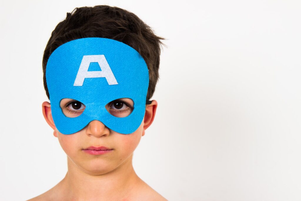 A young boy wearing a mask to break free from the savior complex