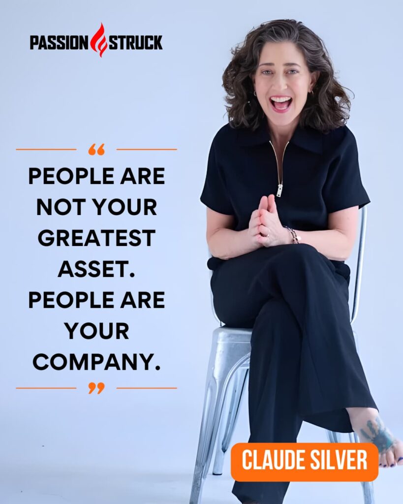 Rewrite Your Life Story: Break Free from the Hidden Scripts of Culture, Work, and Media 1 Claude Silver sits smiling on a metal chair against a light background beside the Passion Struck logo. The image features her quote in bold text: “People are not your greatest asset. People are your company.” Her name appears in an orange box at the bottom right.